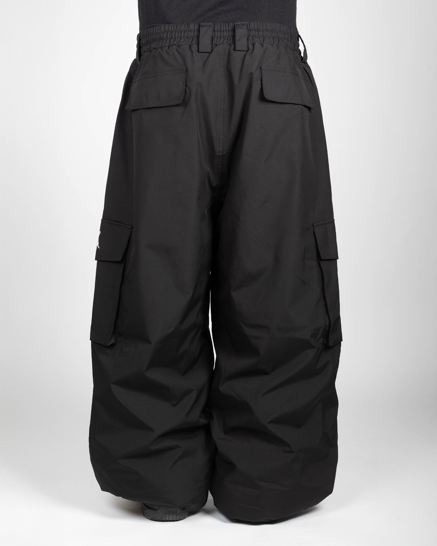 Black baggy snowpants back view on model
