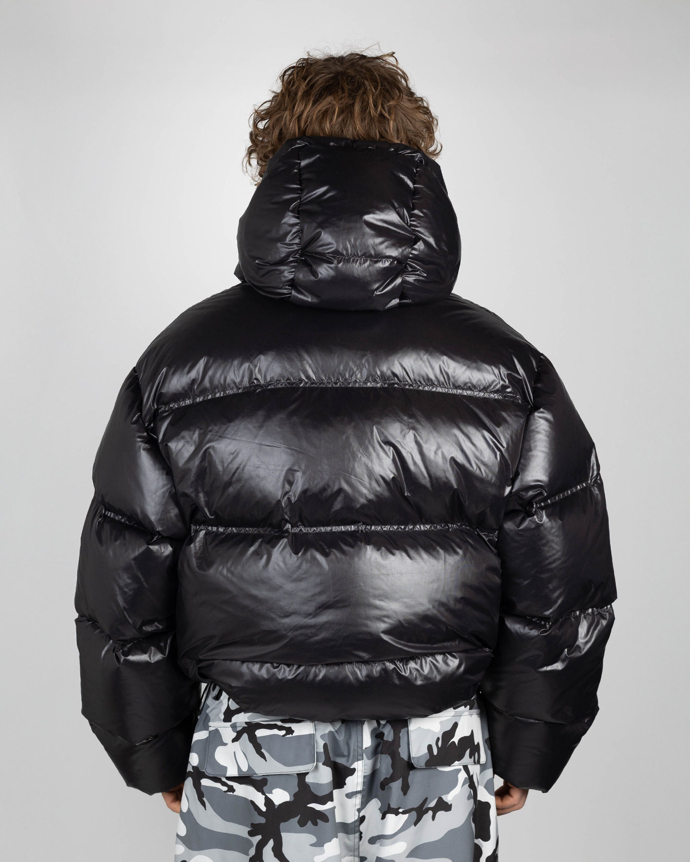 Black puffer jacket back view on model