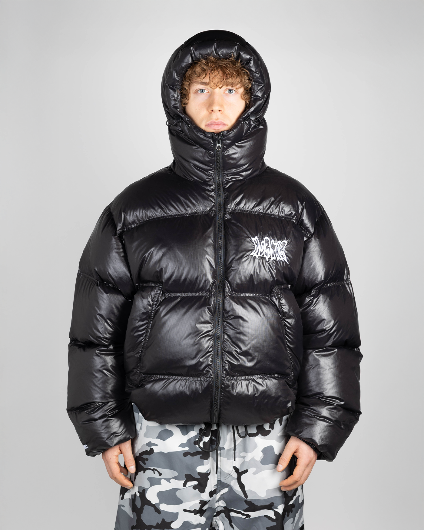Black puffer jacket on model hooded front view