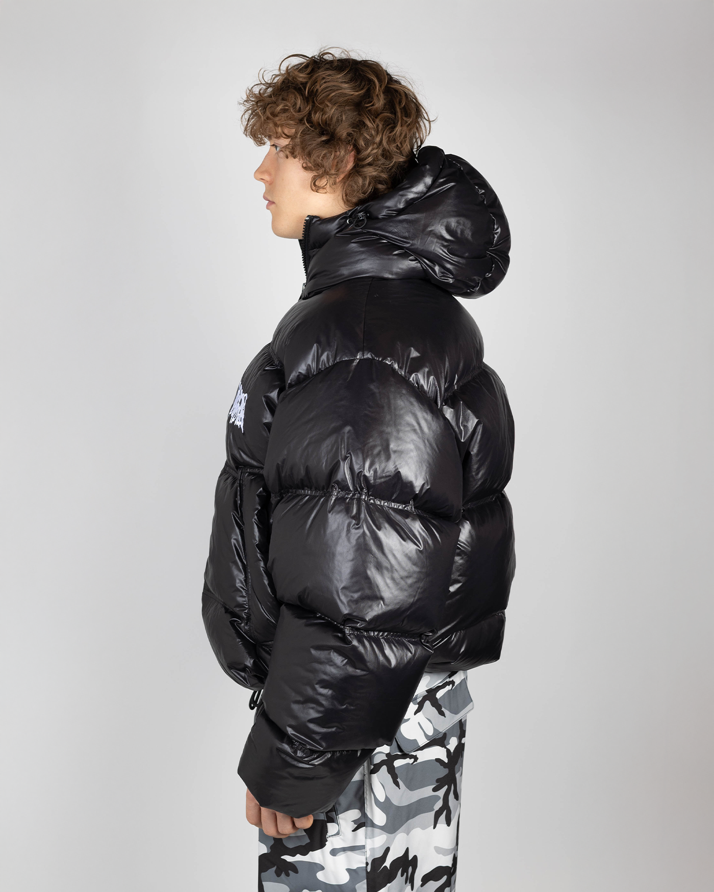 Black puffer jacket side view on model