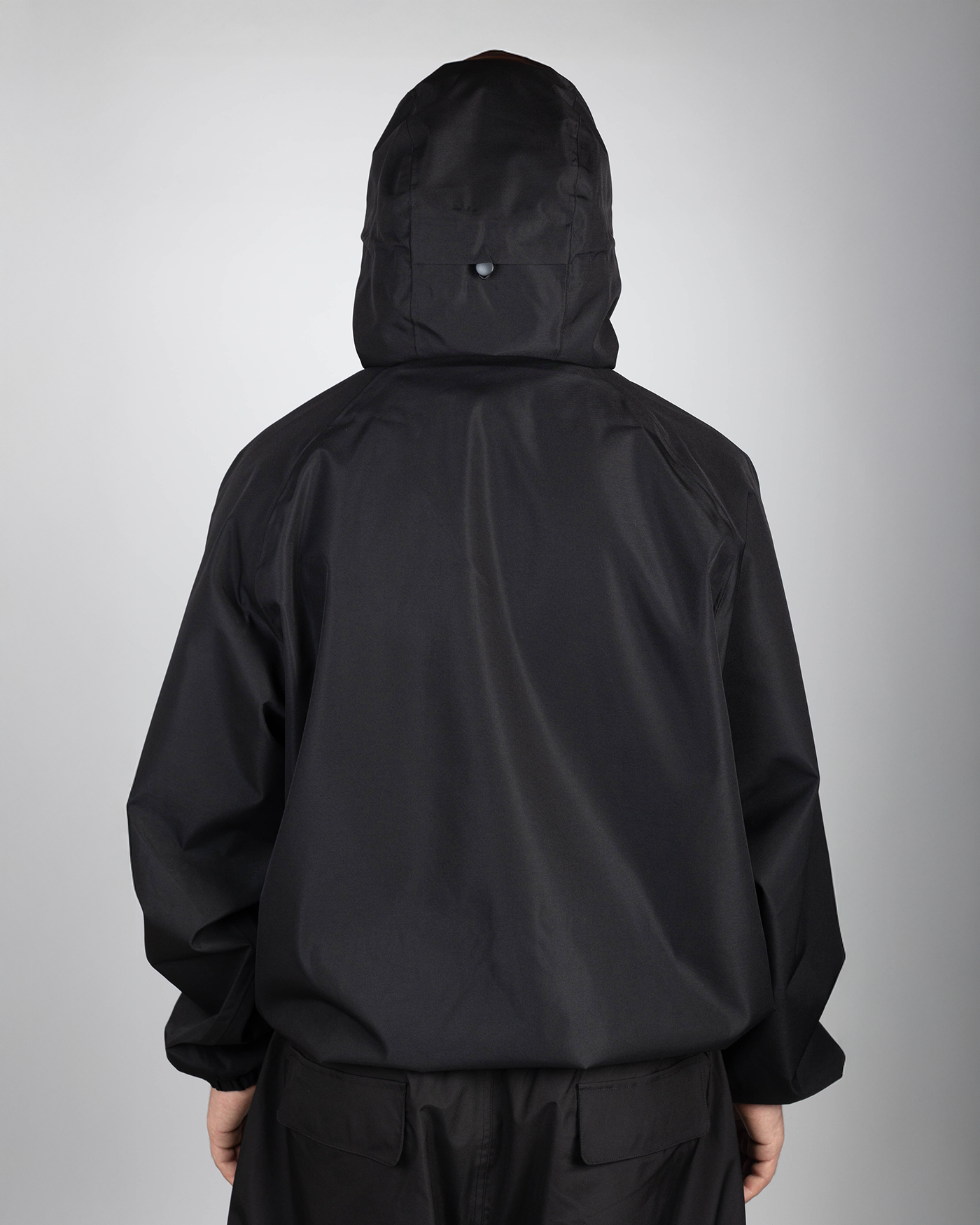 Black snow jacket back view on model