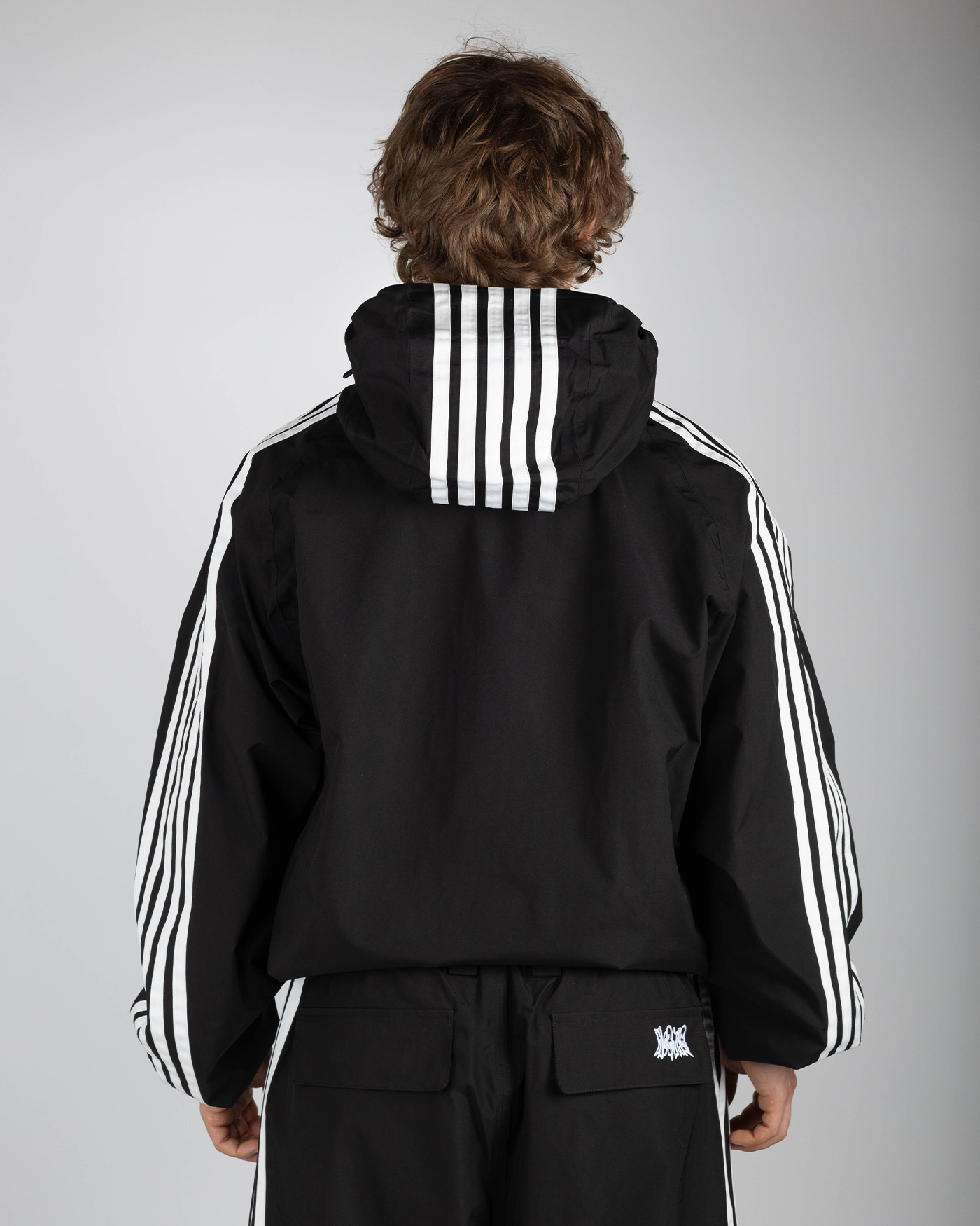 Black stripe snow jacket back view on model