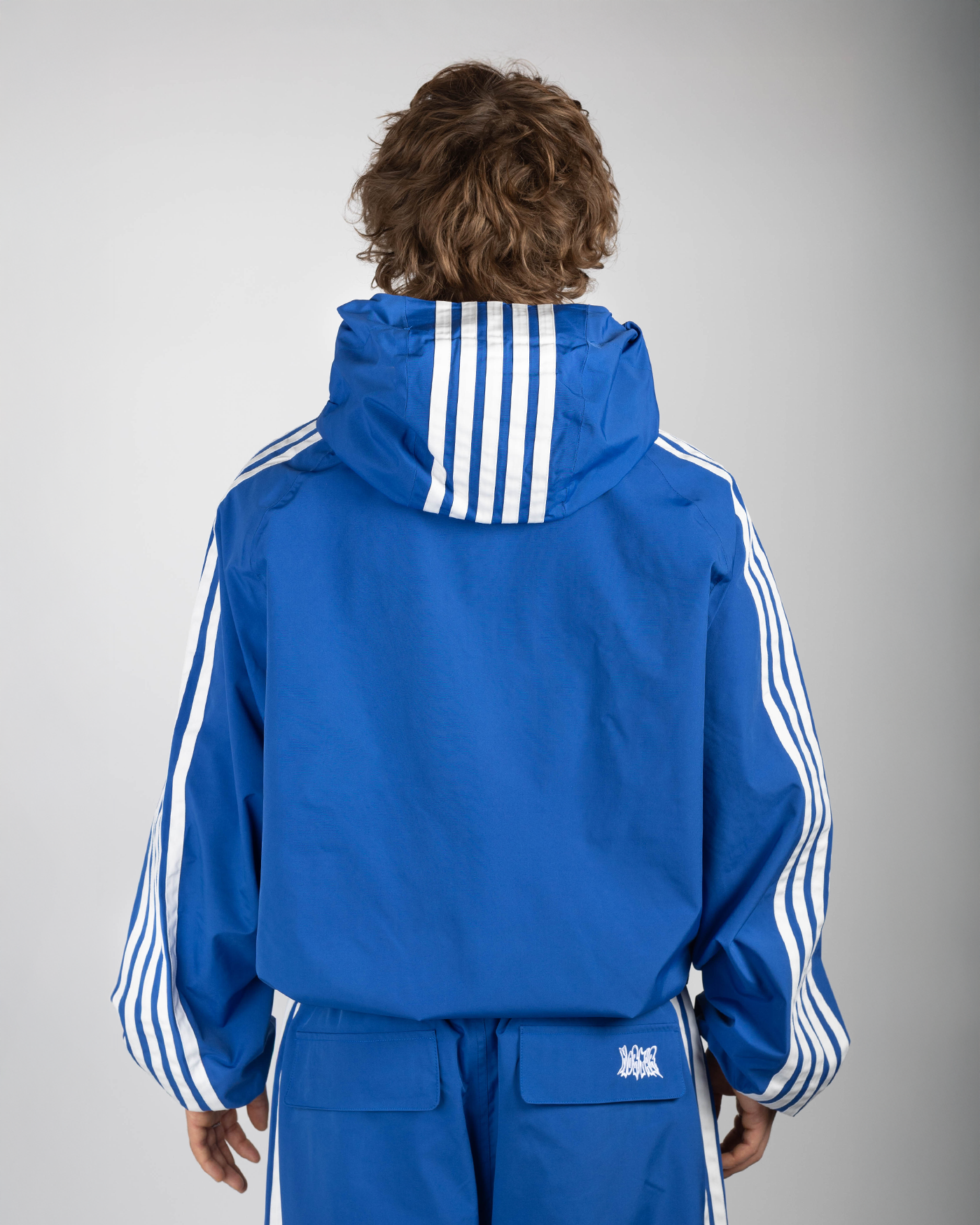Blue stripe snow jacket back view on model
