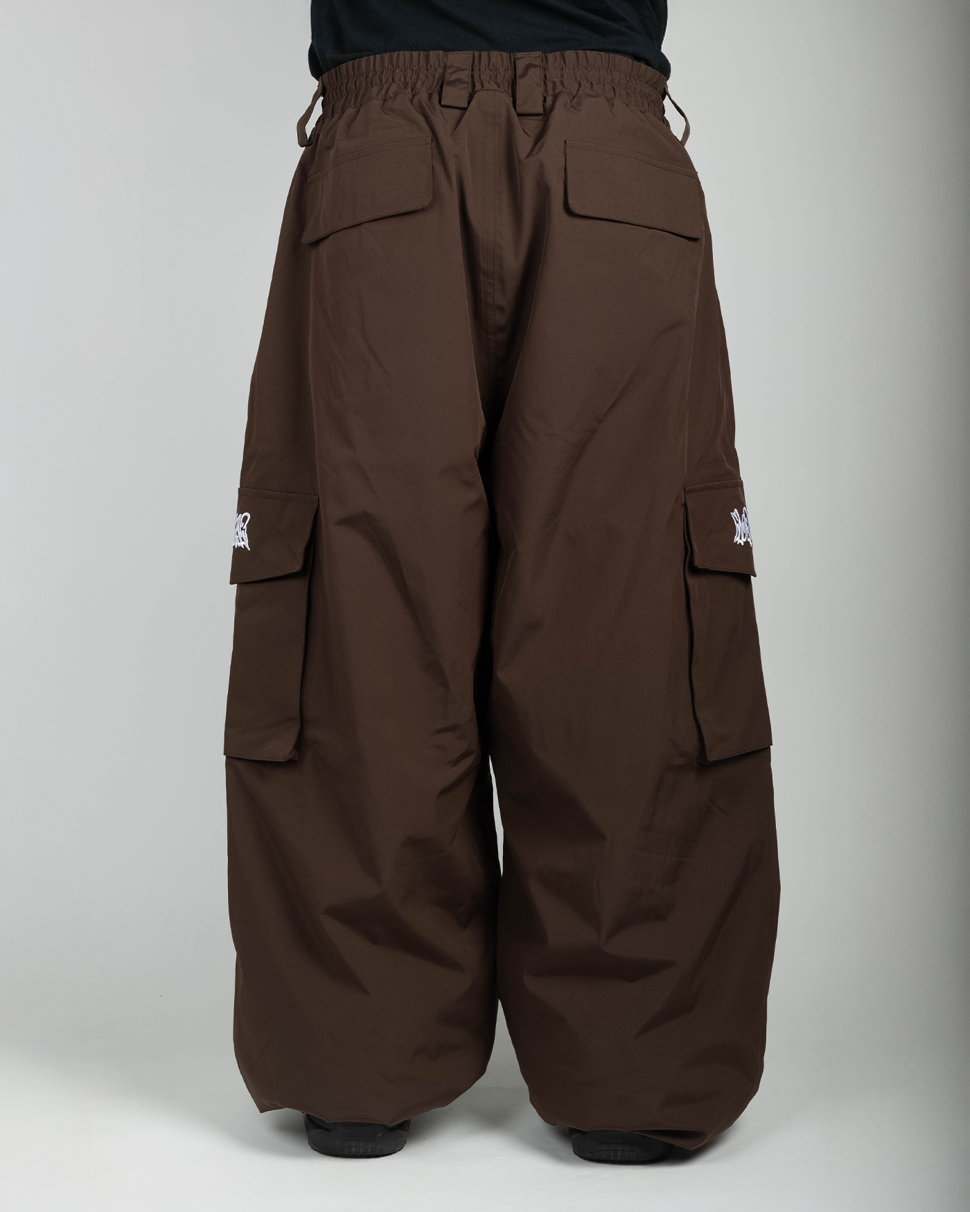 Brown baggy snowpants back view on model