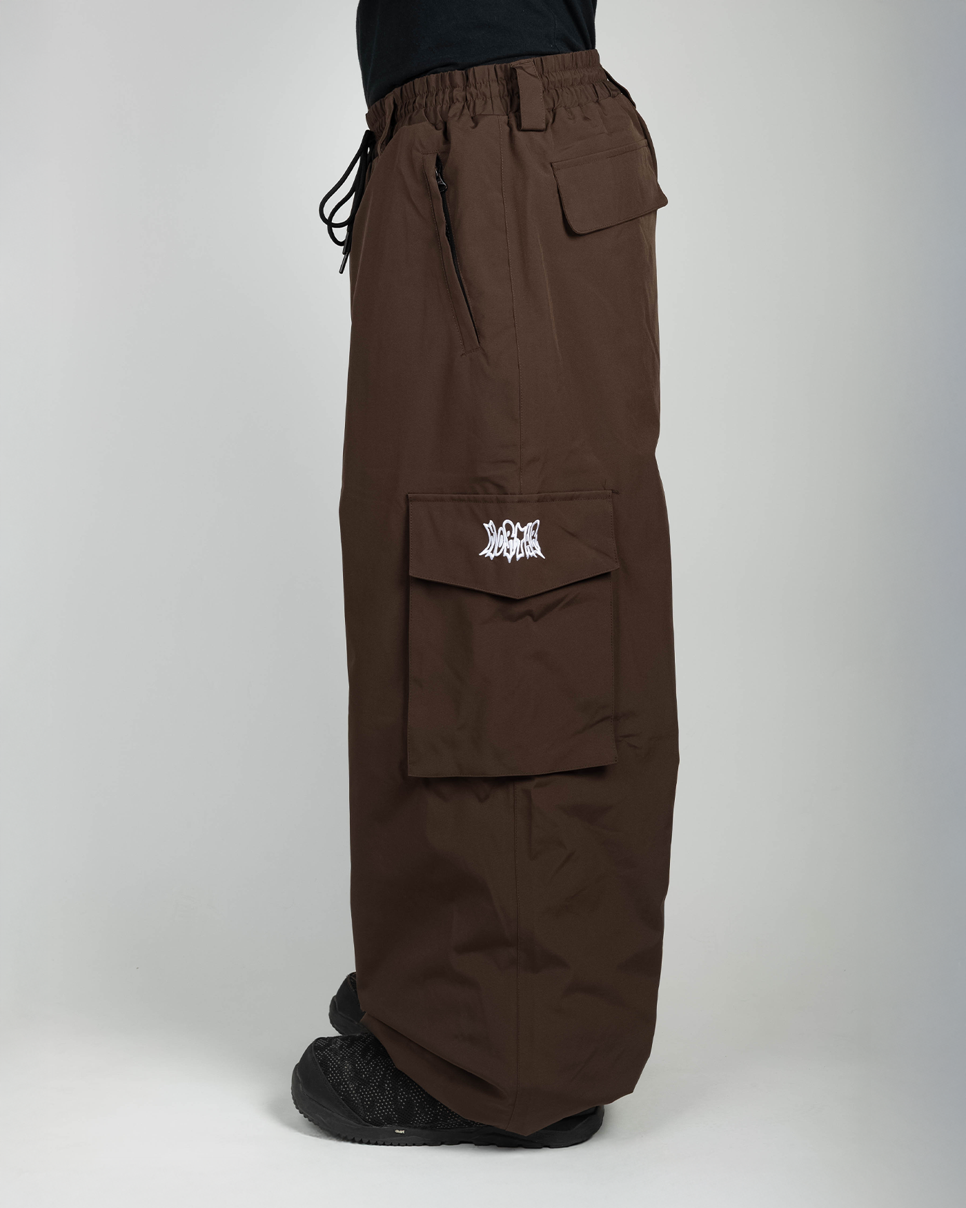 Brown baggy snowpants side view on model