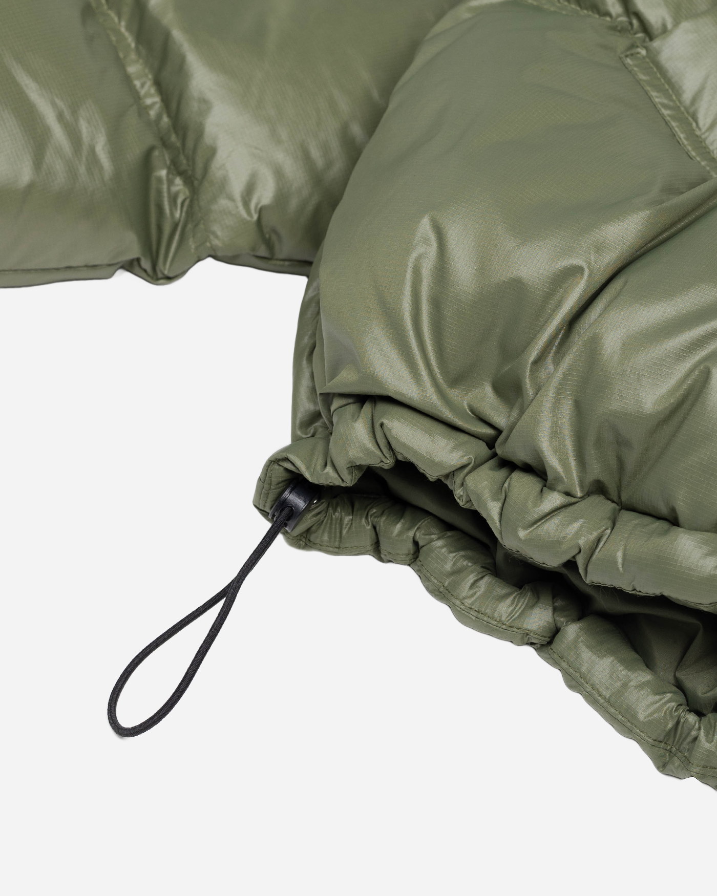 Green puffer jacket adjustable waist detail