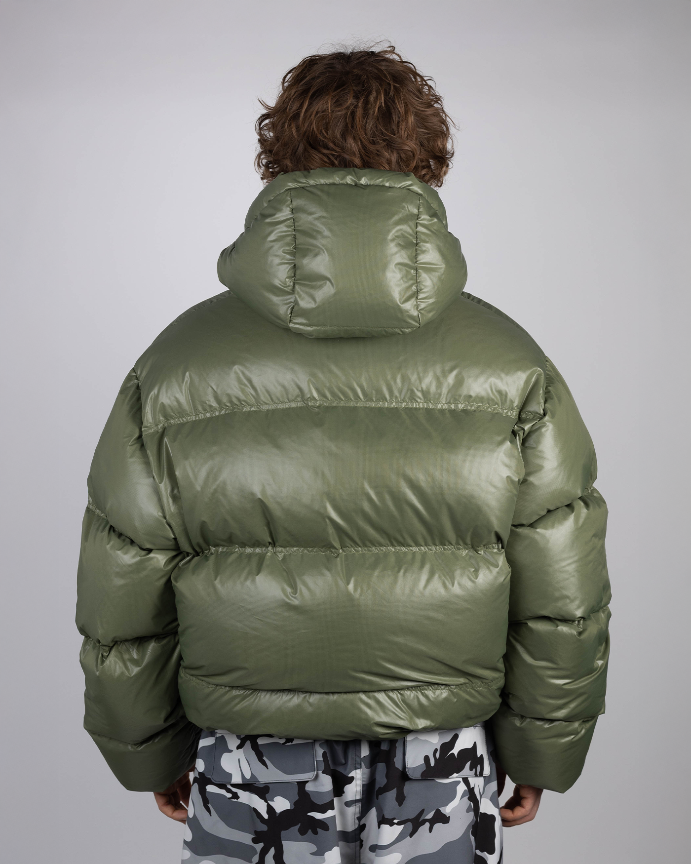 Green puffer jacket back view on model