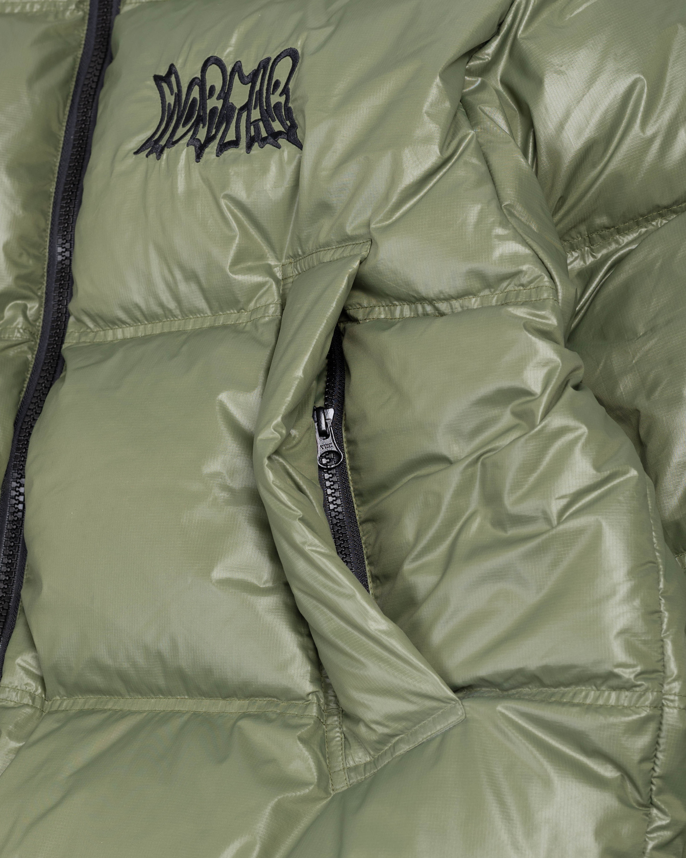 Green puffer jacket pocket detail