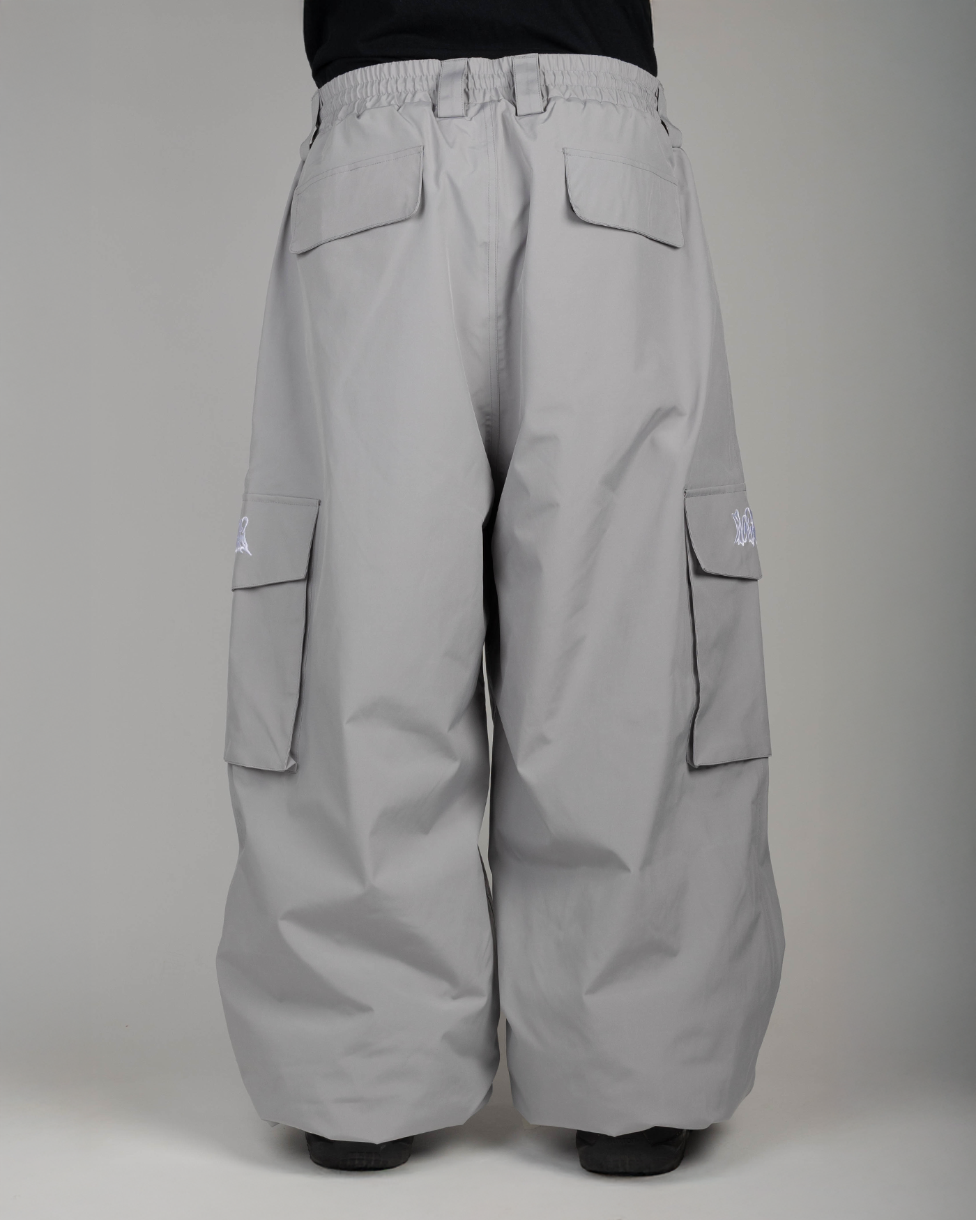 Grey baggy snowpants back view on model